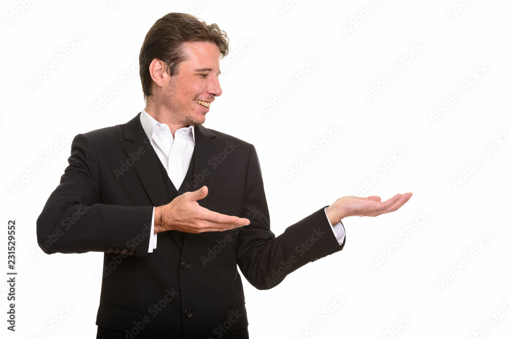 Profile view of happy Caucasian businessman showing something Profile view of happy Caucasian businessman showing something