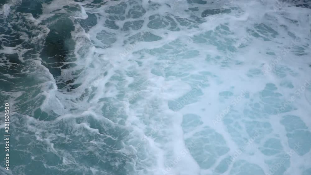 Close up view of ocean water moving with foam in slow motion Close up view of ocean water moving with foam in slow motion