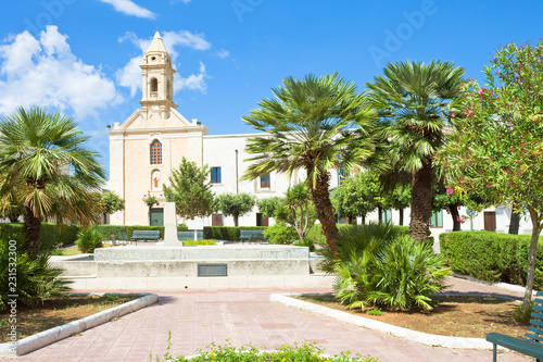 Presicce, Apulia - Relaxing in the calm park in front of the church photo