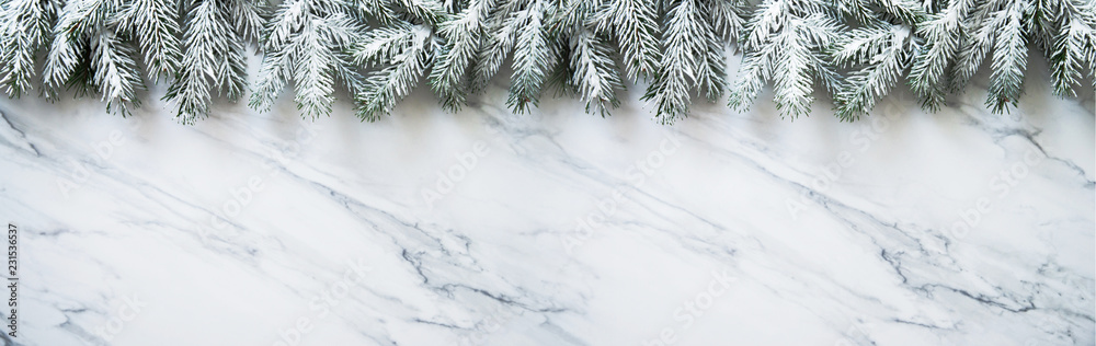 Christmas background with xmas tree on white marble background. Merry christmas greeting card, frame, banner. Winter holiday theme. Happy New Year. Space for text. Flat lay