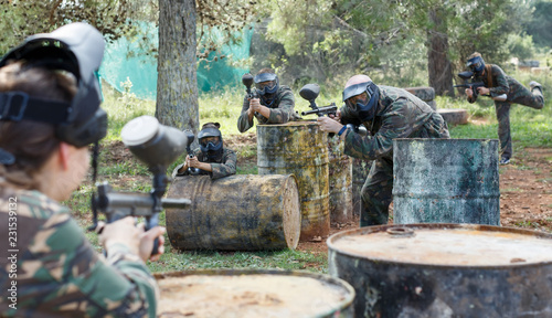 young teams facing on battlefield in outdoor paintball arena