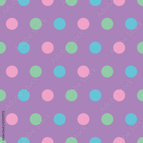 seamless background of polka dots in pink, blue and green on purple
