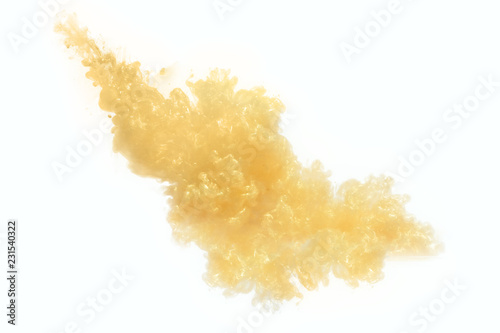 Color drop gold in water, photographed in motion. Ink swirling. Cloud of silky ink under water isolated on white background. Colorful ink in water, ink drop.