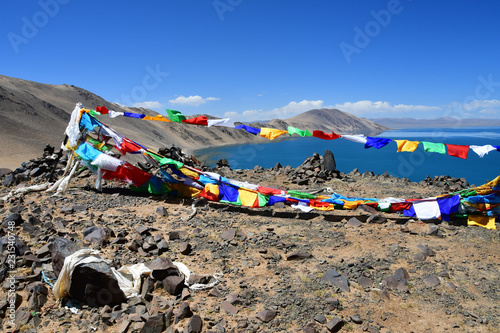 Tibet, Buddhist flags with mantras on Bong Co lake background in summer day