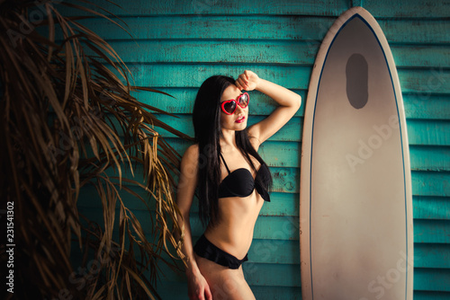 Beautiful girl posing in her summer house photo