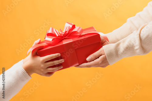 Fotografi Hands of parent giving a  gift to child