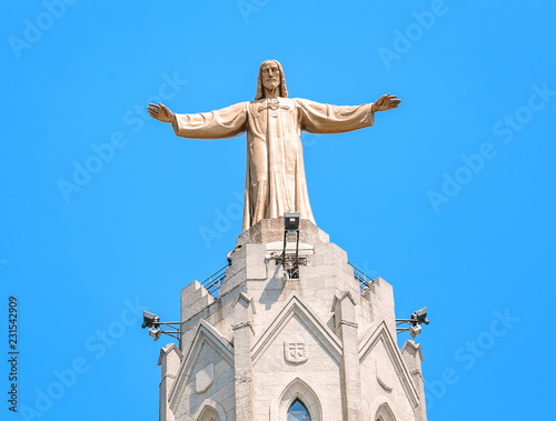 Famous Statue of Jesus Christ with open handed on top of the Church of the Sacred Heart on Tibidabo in Barcelona, Spain