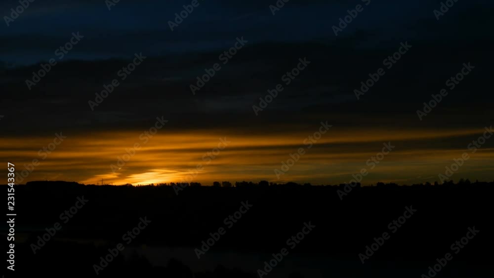 4K. Beautiful scenic sunrise sun moving across fiery red sky background. Timelapse view. 4K. Beautiful scenic sunrise sun moving across fiery red sky background. Timelapse view.