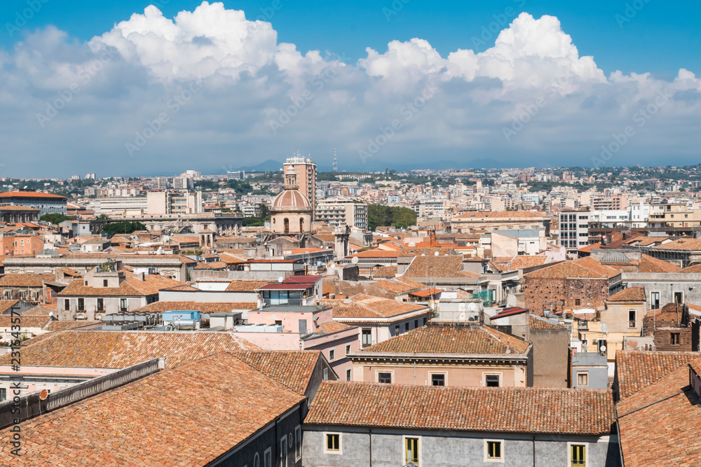 Aerial skyline panoramic view of Catania in September,  old town featuring brown and yellow roofs with Mount Etna at background. Sicily, Italy 