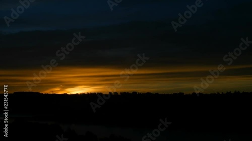 4K. Beautiful scenic sunrise sun moving across red sky. Timelapse view. Seamless cinemagraph video