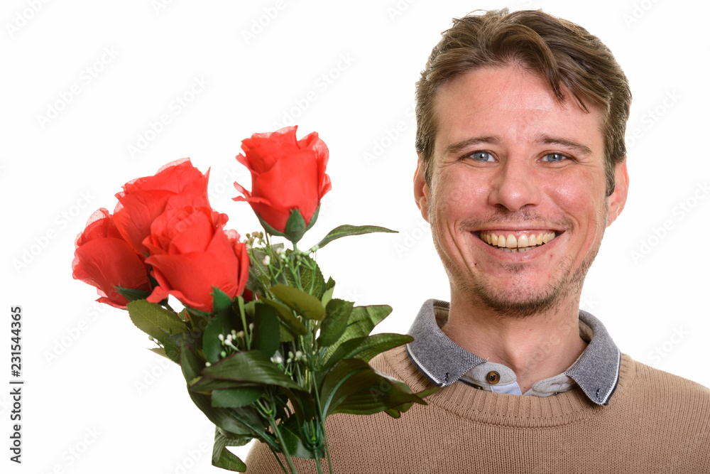 Happy Caucasian man holding red roses ready for Valentine's day Happy Caucasian man holding red roses ready for Valentine's day
