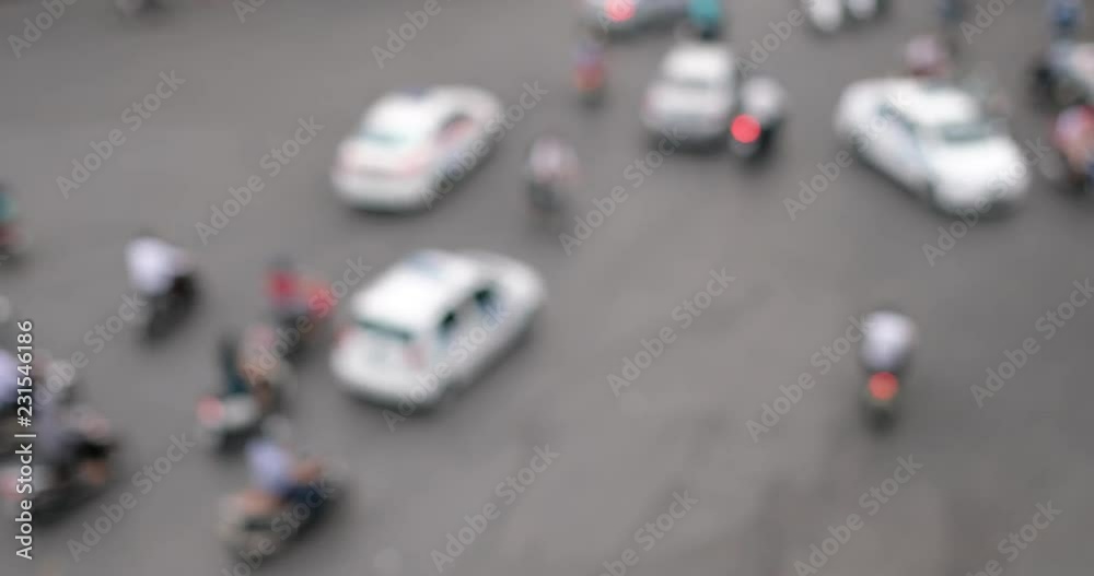 Defocus or out of focus traffic. Day traffic blurry in downtown Hanoi city with lots of motorcycles, motorbike, bus, car, and people walking transport on the road. Aerial view city in rush hour Defocus or out of focus traffic. Day traffic blurry in downtown Hanoi city with lots of motorcycles, motorbike, bus, car, and people walking transport on the road. Aerial view city in rush hour