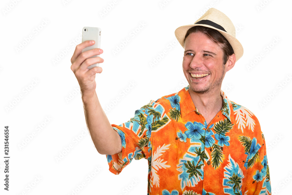Happy Caucasian man taking selfie with mobile phone ready for va Happy Caucasian man taking selfie with mobile phone ready for va