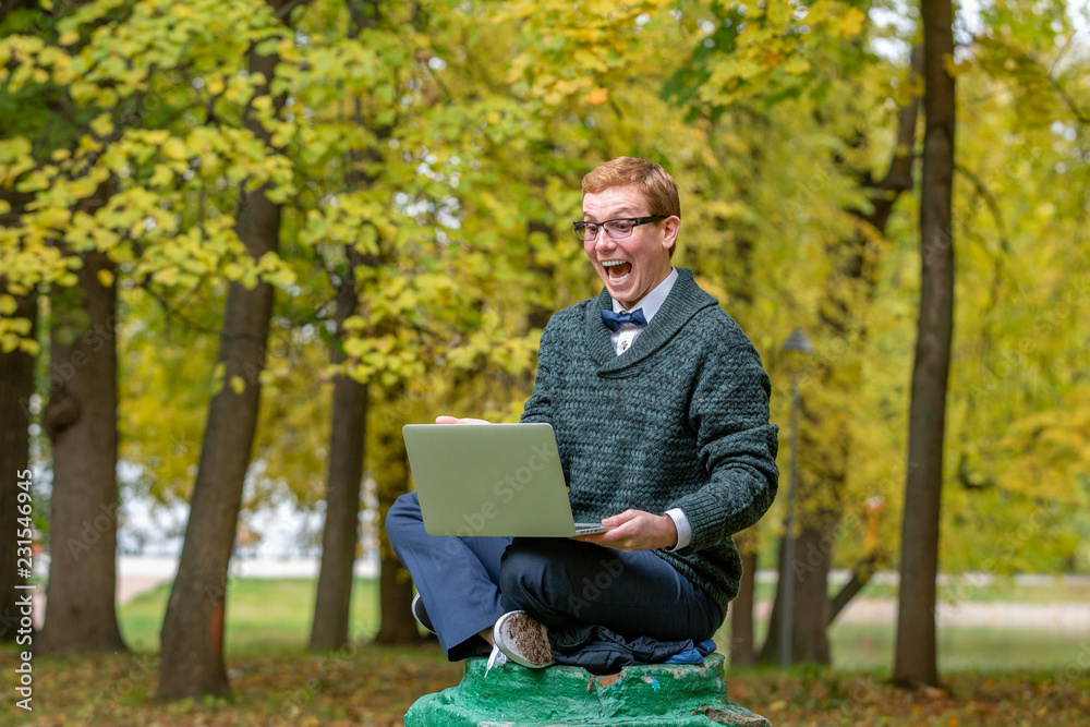 A man with lap top on a pedestal who pretends to be a statue in the the autumn park. Get idea A man with lap top on a pedestal who pretends to be a statue in the the autumn park. Get idea