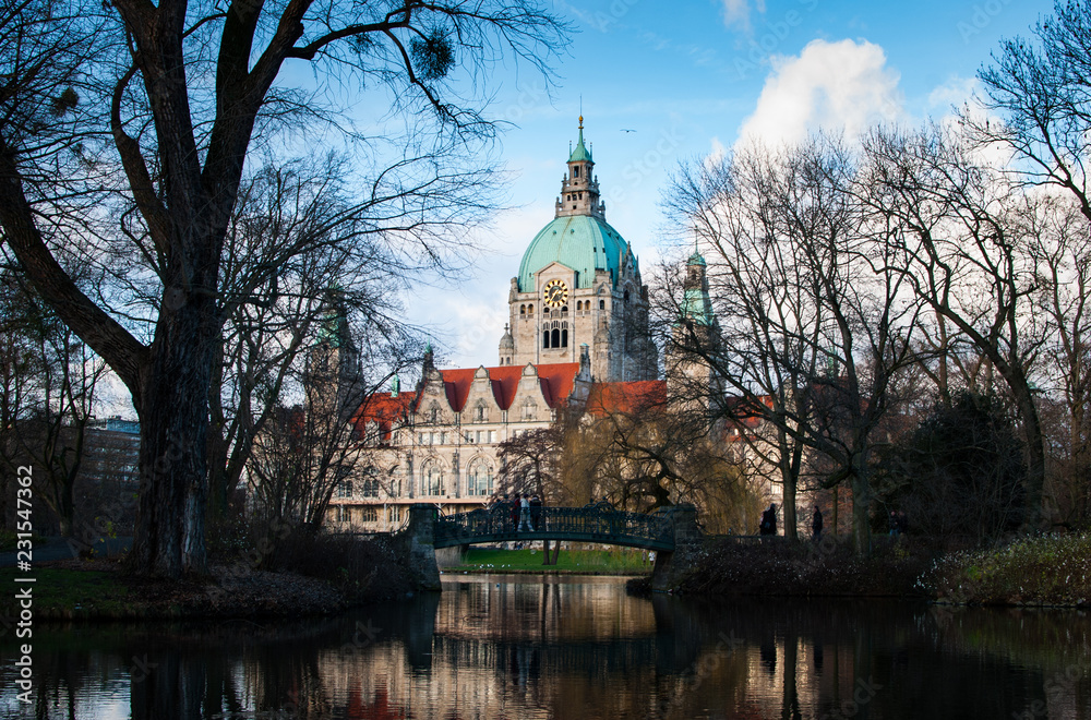 The town hall of hanover and it's garden reflected in the water in Germany