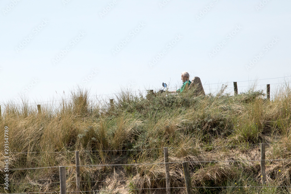 Obraz premium People walking in the dunes