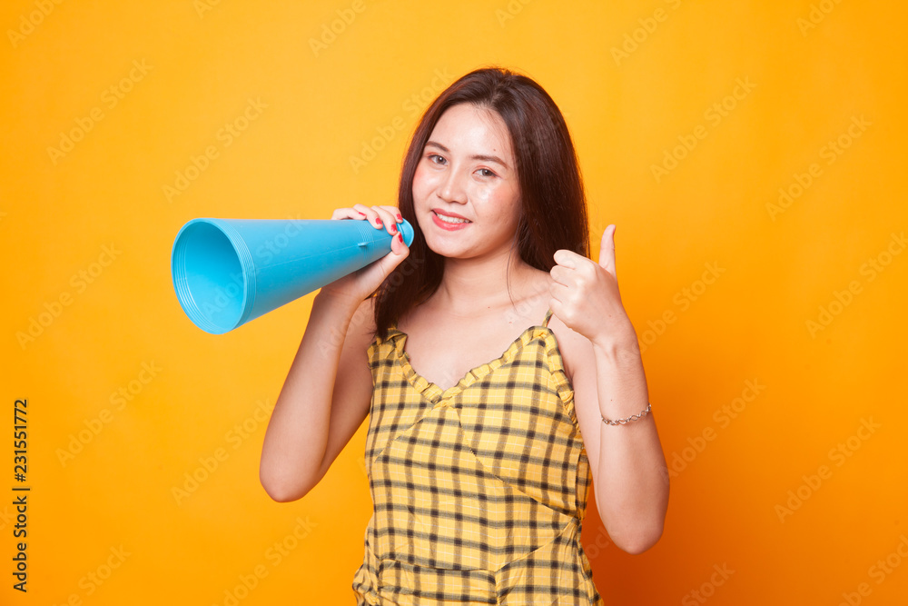 Beautiful young Asian woman show thumbs up announce with megaphone. Beautiful young Asian woman show thumbs up announce with megaphone.