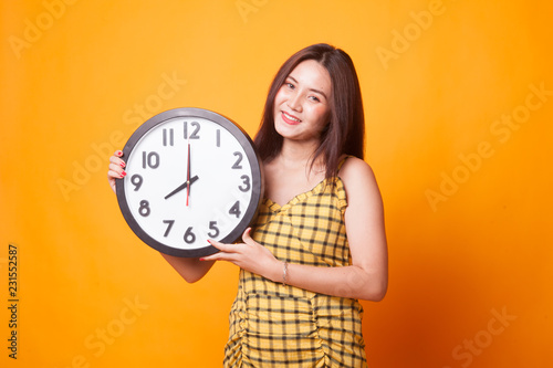 Young Asian woman with a clock.