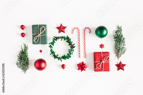 Christmas composition. Gifts, fir tree branches, red decorations on white background. Christmas, winter, new year concept. Flat lay, top view photo