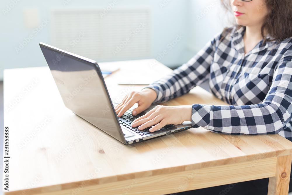 Fototapeta premium Technology, business and people concept - Close up of woman's hand typing on keyboard