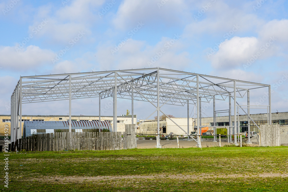 Fototapeta premium skeleton of metal building under construction, industrial object