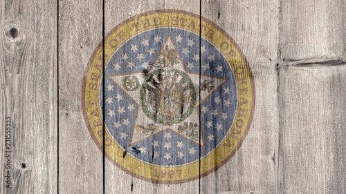 USA Politics News Concept: US State Oklahoma Seal Wooden Fence Background