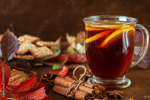 A cup of hot tea on the background of autumn foliage