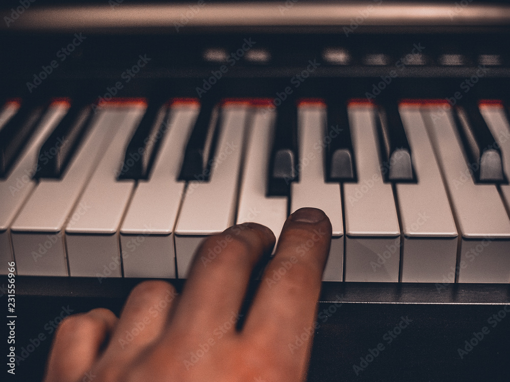 Fototapeta premium Playing on classic electrical piano keyboard