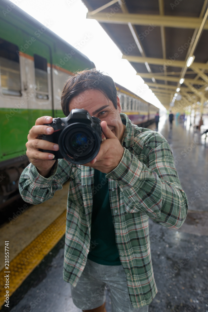 Handsome Persian tourist man at the railway station in Bangkok, 