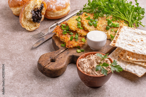 Tasty Hanukkah celebration food on vintage cutting board photo