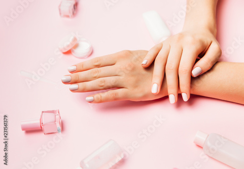 Beautiful female hands with trendy stylish manicure on pink background.