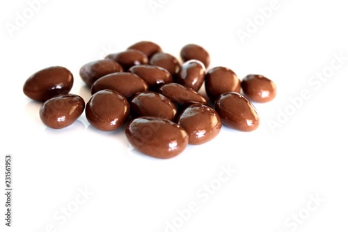 Candy balls made of almonds covered mik chocolate, white background