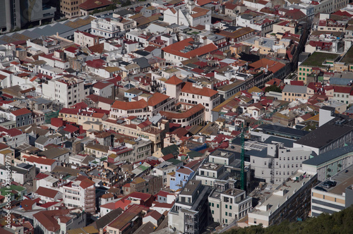 A small town from above with lots of buildings and many red rooftops.