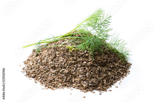 Heap of dry dill seeds isolated on white background