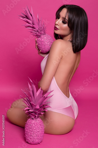 Fashion model, pink background, girl with a pineapple, summer mood