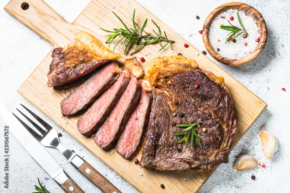 Grilled beef steak ribeye on white. Grilled beef steak ribeye on white.