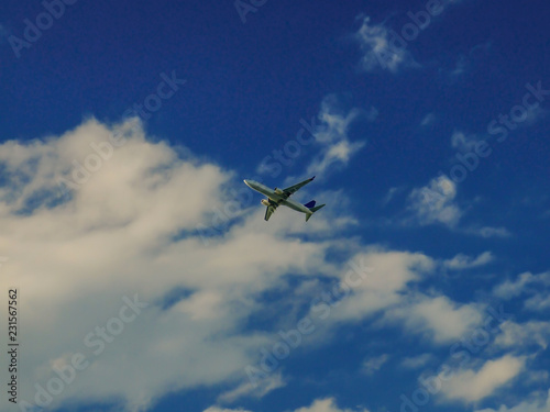 Commercial airplane flying under the clouds