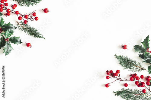 Christmas composition. Frame made of christmas plants on white background. Flat lay, top view, copy space photo