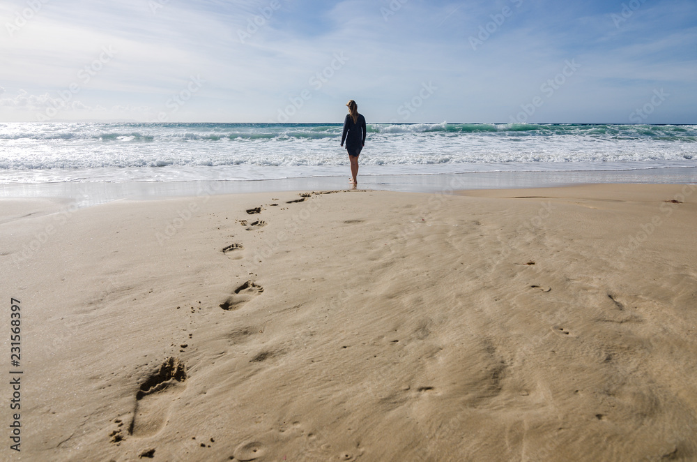 Woman Walking on The Beach. Footprints in Sand. Woman Walking on The Beach. Footprints in Sand.