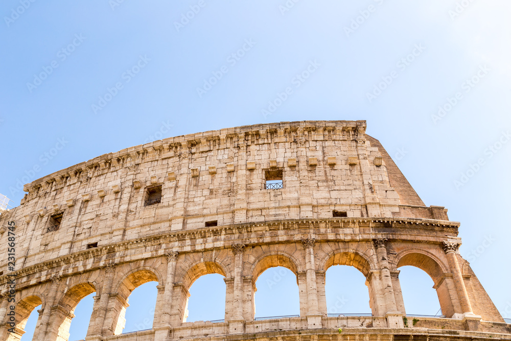 Colosseum with clear blue sky, Rome, Italy  Rome landmark and antique architecture  Rome Colosseum is one of the best known monuments of Rome and Italy