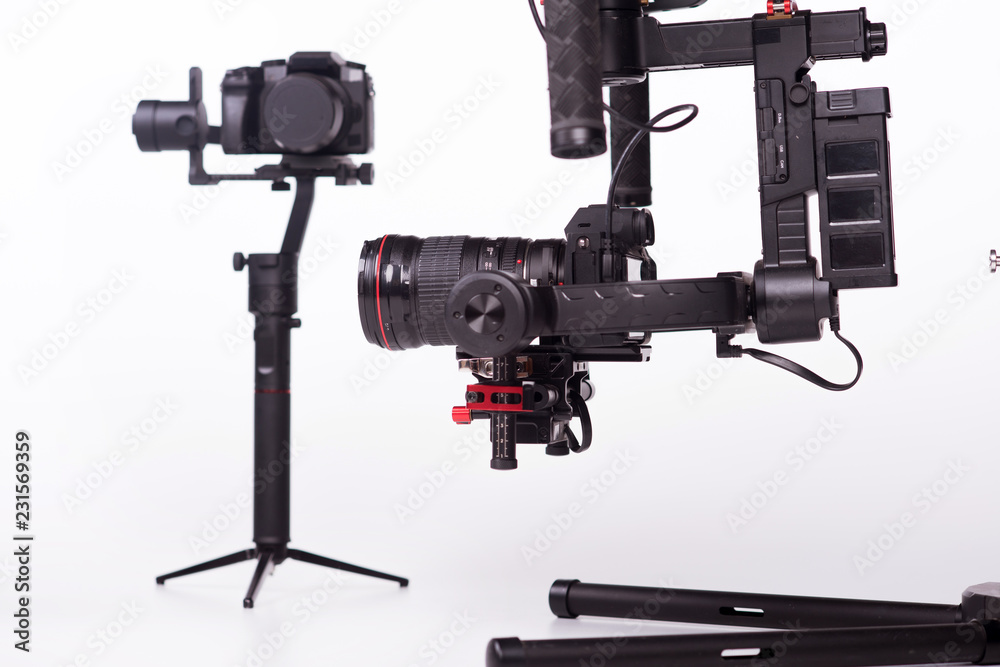 Sistem stabilization video camera and lens on steady equipment support such as gimbal steady or stabilized. White background Sistem stabilization video camera and lens on steady equipment support such as gimbal steady or stabilized. White background