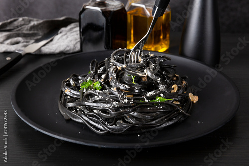 Pasta with wheat germ and black squid ink. Mushroom sauce. Olive oil and spices. Copy space.