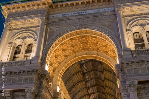 Milan, Italy. Arch of Galleria Vittorio Emanuele II in the evening with golden illumination, view from below
