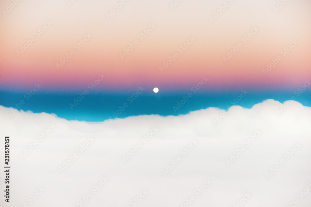 Sky and clouds at sunset with full moon rising, aerial view from plane Sky and clouds at sunset with full moon rising, aerial view from plane