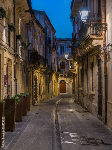 A picturesque road in Siracusa old town (Ortigia) at night. Sicily, southern Italy.