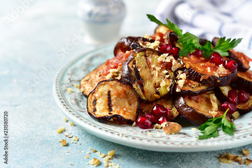 Photography Grilled eggplants in tomato sauce with walnuts and pomegranate seeds