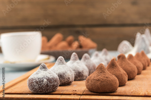 Chocolate candies in white and brown powder.