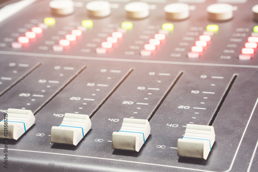 Professional audio mixing console with faders and adjusting knobs - radio / TV broadcasting