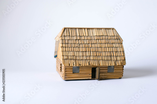 Miniature model of wooden old  house on white background