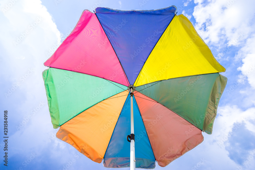 angle view of colorful umbrella under sunshine, summer season angle view of colorful umbrella under sunshine, summer season